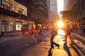 People crossing on street at sunset, New York