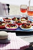 Tomato and olive muffins in paper case in serving tray