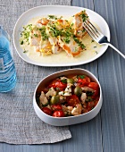 Chicken cutlet on plate and chopped chicken with vegetables in bowl