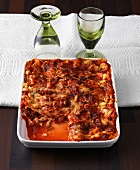 Chicken lasagne with tomatoes in baking dish