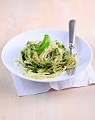 Spaghetti with basil pesto on plate 