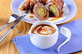 Beef roulade on plate with balsamic sauce in bowl