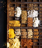 Various grain and flour types in a seedling tray