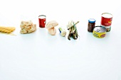Ingredients for tortellini with tomato puree and asparagus on white background