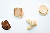 Toast, whole grain bread, aufbackbro and aufbackbrotchen on white background