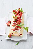 Swiss roll with strawberries and lemon balm