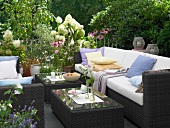 Garden terrace with wicker furniture and plants