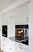 White open steam oven integrated in wall cabinet