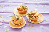 Three peach pine nut tarts on plates
