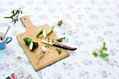 Vegetables with knife on wooden board, copy space