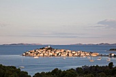 View of Primosten town and mountains on the horizon of Adriatic sea in Croatia