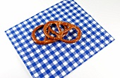 Two pretzels on checked napkin