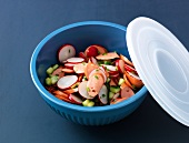 Wiener sausages salad with radishes in bowl with lid