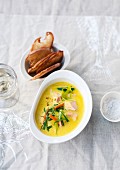 Saffron fish soup with vegetables and grilled bread