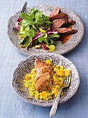 Salad with roasted beef and quail with mango and bulgar on plates
