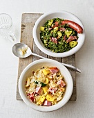 Kale stew and cabbage stew in bowls on wooden board, overhead view