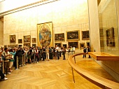 Tourists photographing Mona Lisa in The Louvre Museum, Paris, France