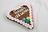 Heart shaped lebkuchen cake with icing on top on white background