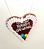 Heart shaped gingerbread with icing hanging on wall