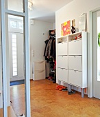 White shoe cabinet with shoes in hall