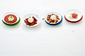 Four different type of desserts with vanilla ice cream on plates