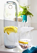 Lemon water in glass and carafe