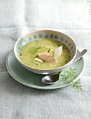 Cream of zucchini soup with trout in bowl