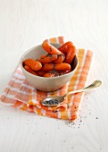 Bunch of carrots with poppy seed butter in bowl