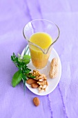 Vinaigrette in jar with nuts on plate, low GI diet food