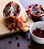 Halved pomegranate on chopping board, step 2