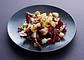 Red cabbage and apple salad with mozzarella cheese on plate