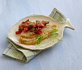 Plaice with tomatoes and bacon sauce in serving dish