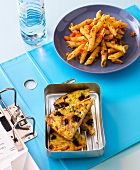 Pasta with walnut and tomato pesto on plate, pasta frittata in serving dish