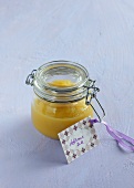 Apple sauce in glass jar with placard