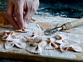 Close-up of dough being pressed while preparing farfalle pasta