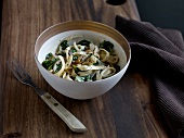 Noodles with spinach and pecorino cream in bowl
