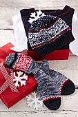 Close-up of woolly hat and socks on red box