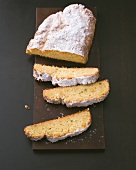Loaf and slices of quark stollen on wooden board