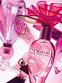 Close-up of various pink perfume bottles
