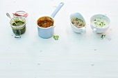 Various sauces in jar, saucepan, sauceboat and cup