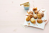 Banana fritters with sesame honey on tissue paper