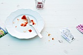 Empty plate with fork and movie tickets on white background