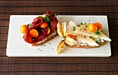 Bread with bresaola and goat cheese garnished with physalis herb on tray