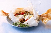 Parchment with tomato and mushroom on plate