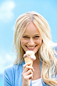 Woman eating ice-cream, smiling