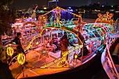 View of people in illuminated boat on Nile river, Cairo, Egypt