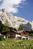 View of Baita Cianci with rocky mountains at Trentino, Italy