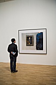 Rear view of visitor at art exhibition in Whitechapel Gallery, London, UK