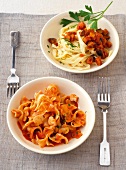 Tomato and mushroom sauce with tagliatelle and eggplant in serving dish