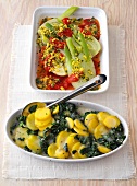 Potato and spinach bake and fennel gratin on tray